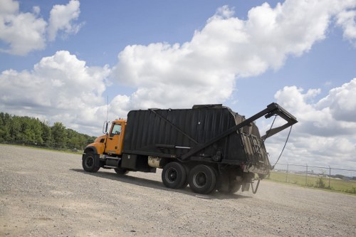 Commercial rubbish collection vehicle at a business premises